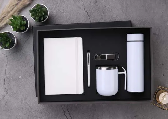 White Aroma Affair gift set with diary, pen, keychain, handled mug and temperature-display flask in a black tray.