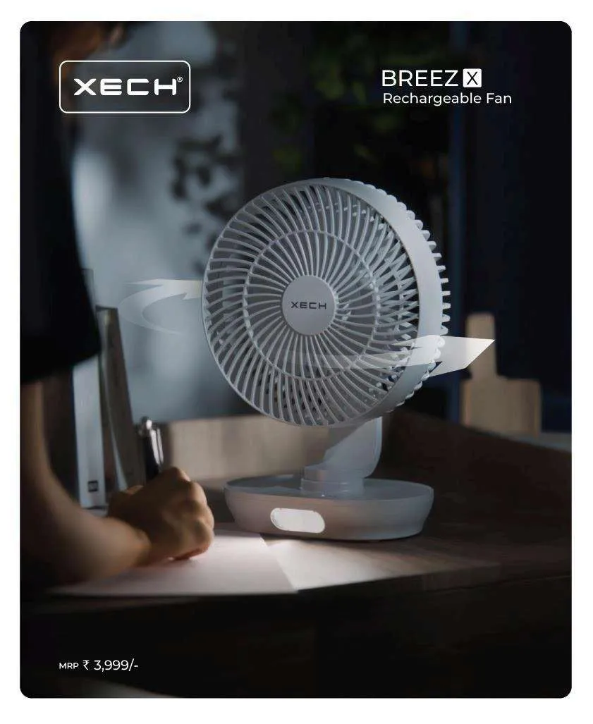 XECH BreezX white rechargeable desk fan with lit base panel on a desk in low light