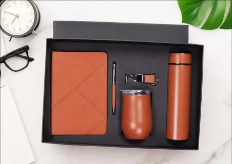 Tan Delight 6-in-1 gift set with leatherette diary, pen, keychain, tumbler and bottle in a black box.