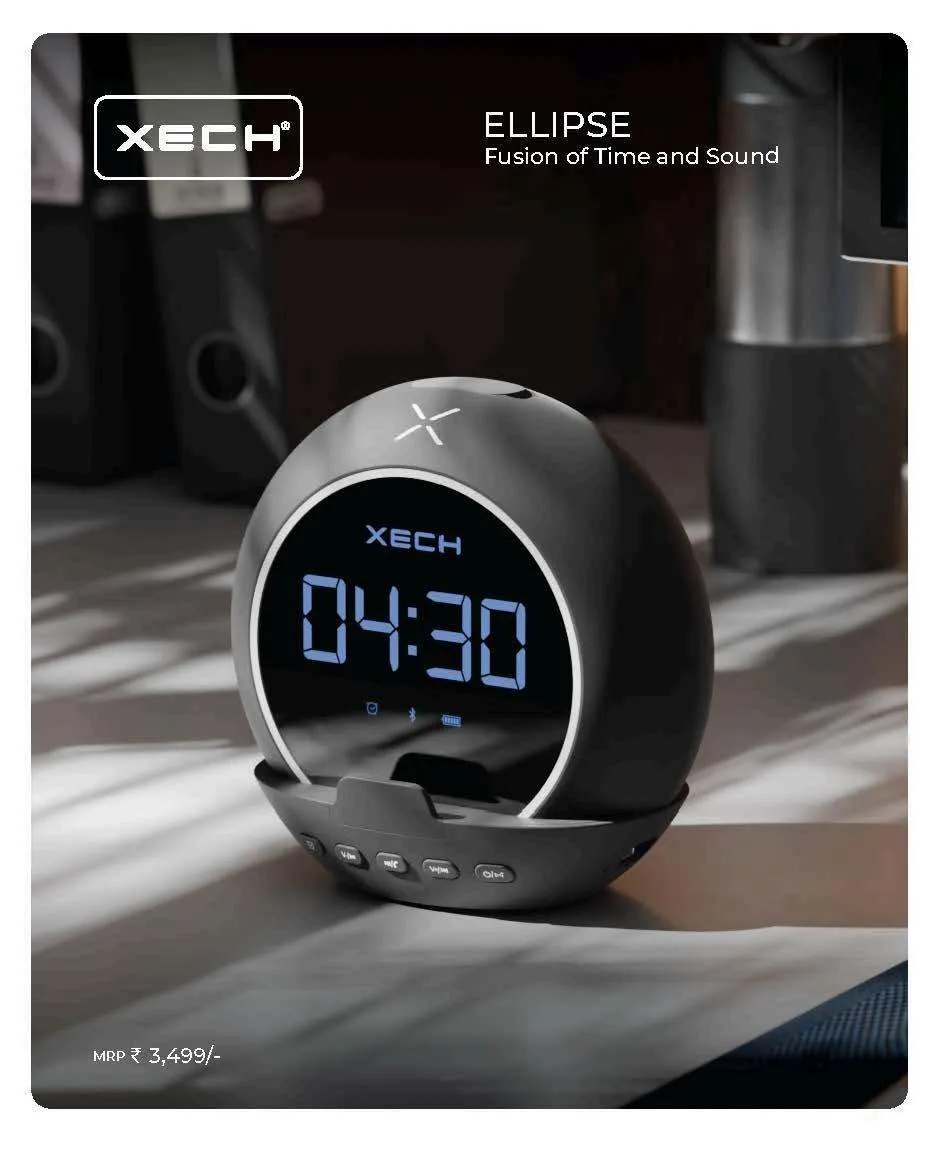 Dark grey XECH Ellipse orb-shaped clock speaker showing 04:30 in blue LED with a phone cradle dock.