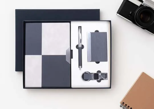 Navy gift box with grey checkered diary, metal pen, card holder and keychain.
