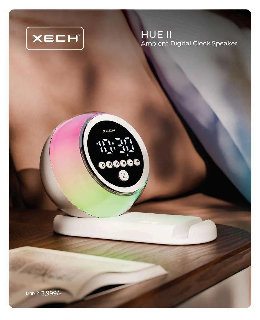 Black XECH Desk Boss lantern-shaped wireless speaker with front clock display and carry loop on a desk.