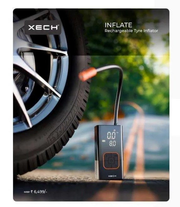 XECH Inflate compact rechargeable tyre inflator in black with orange accents and digital display, standing beside a car wheel on a road.