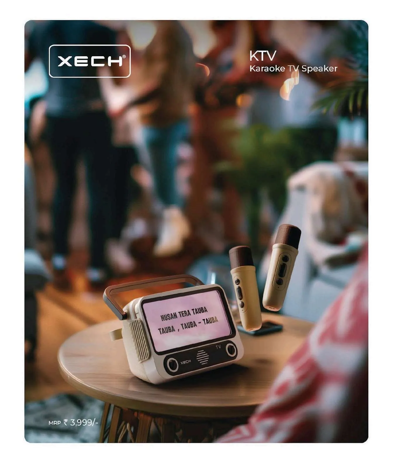 Cream XECH KTV karaoke TV speaker with lyrics on screen and two wireless microphones on a small table