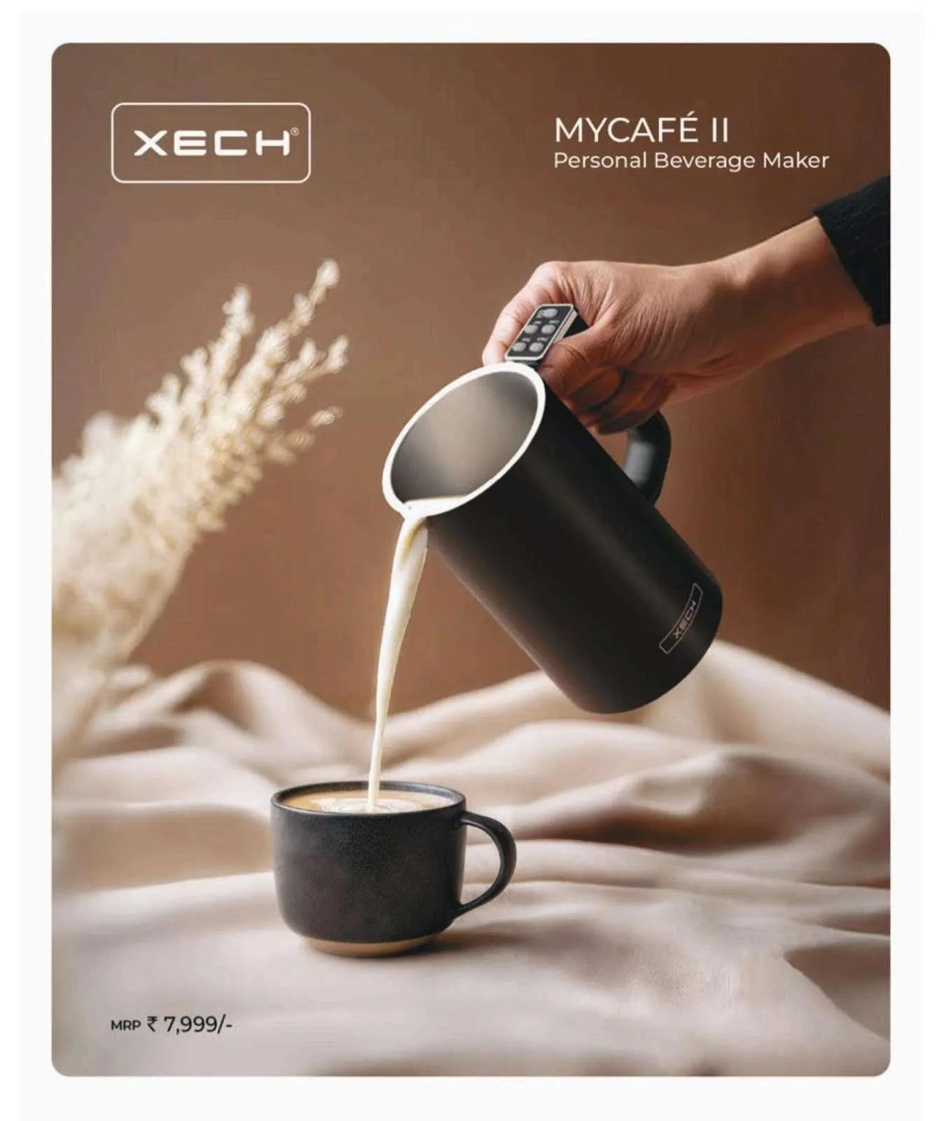 XECH My Cafe II matte-black personal beverage maker pouring a frothy drink into a dark ceramic cup.