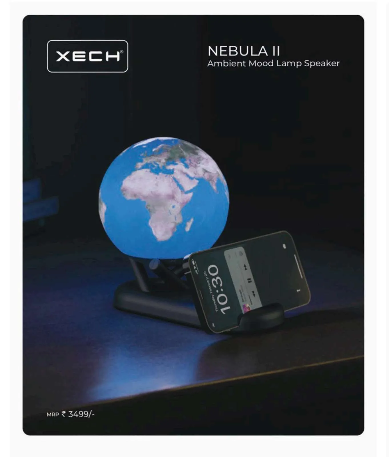 Glowing blue Earth-globe XECH Nebula II lamp speaker with a phone resting in its black base stand