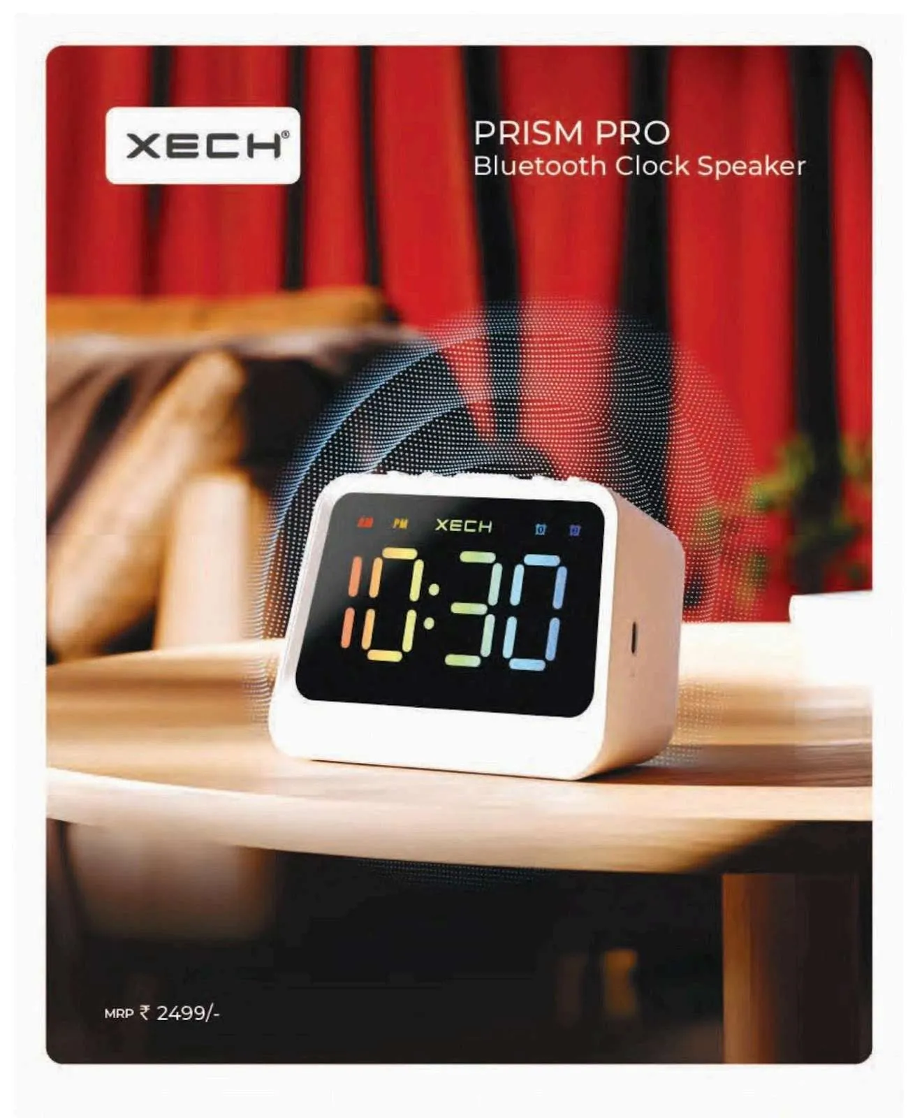 White cube-shaped XECH Prism Pro Bluetooth clock speaker showing 10:30 in rainbow LED digits on a round wooden table.