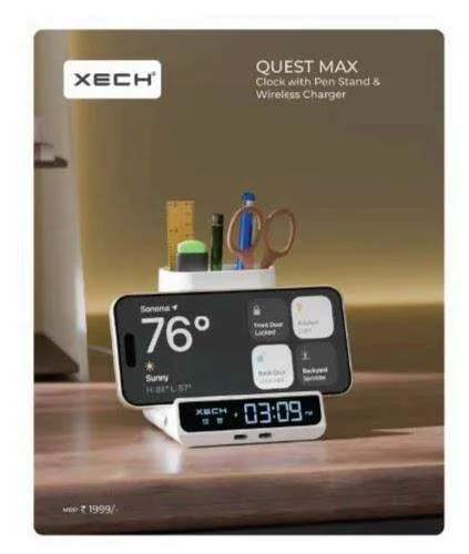 White XECH Quest Max desk unit with a pen stand, a phone on its wireless charging stand, and a blue 03:09 LED clock at the base.