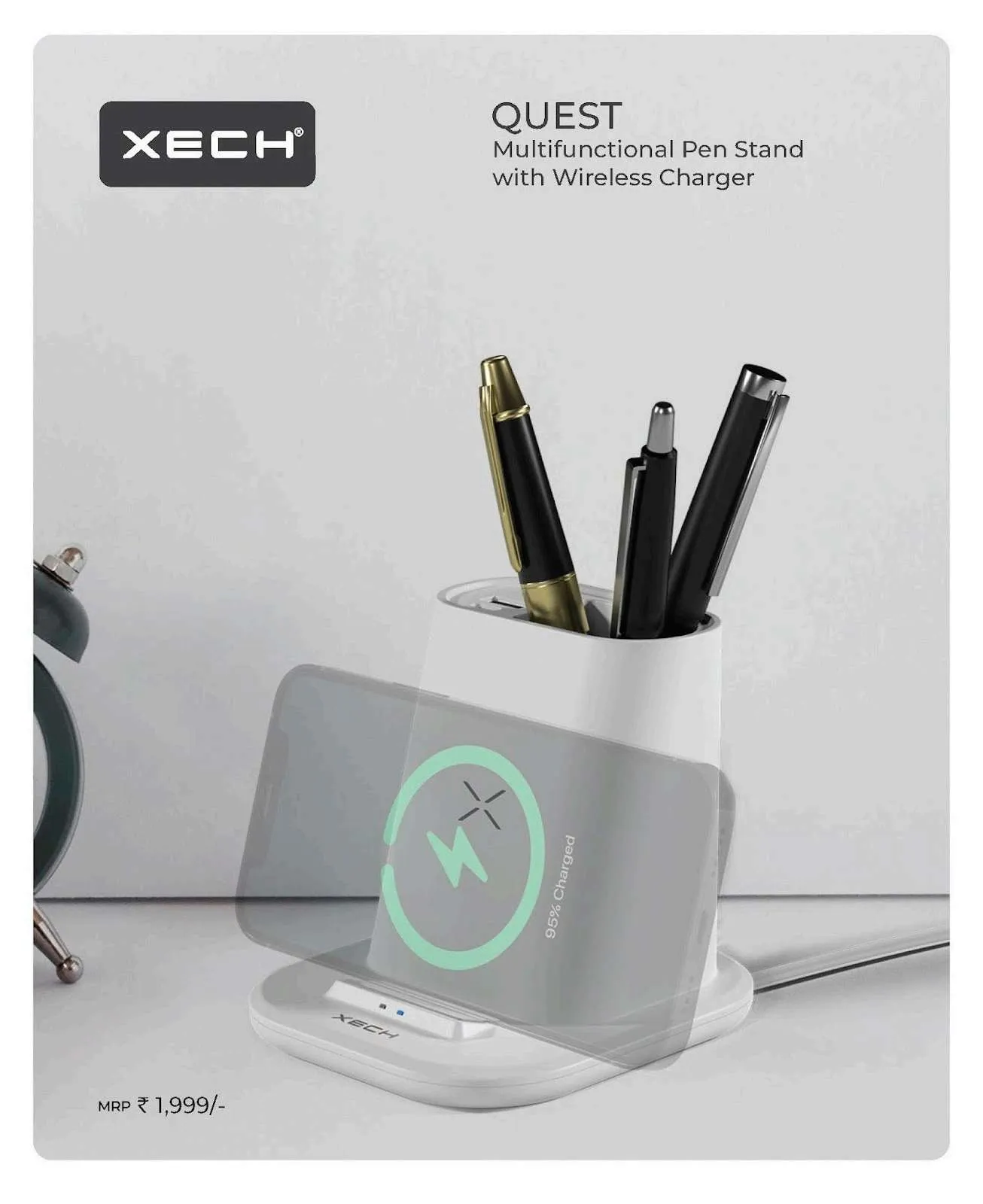 White XECH Quest pen stand with an angled wireless charging cradle holding pens, beside a small clock.