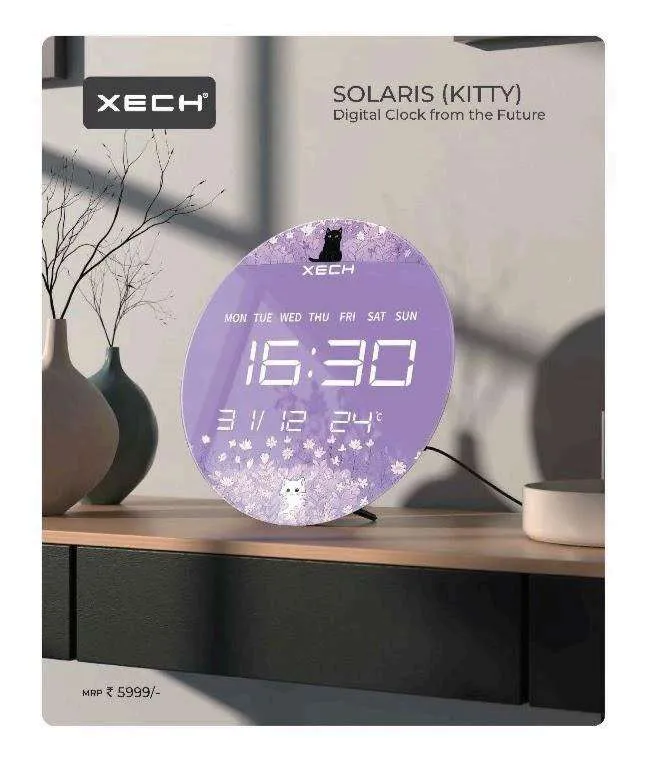 Round XECH Solaris Kitty digital clock with lavender floral LED display on a wooden console