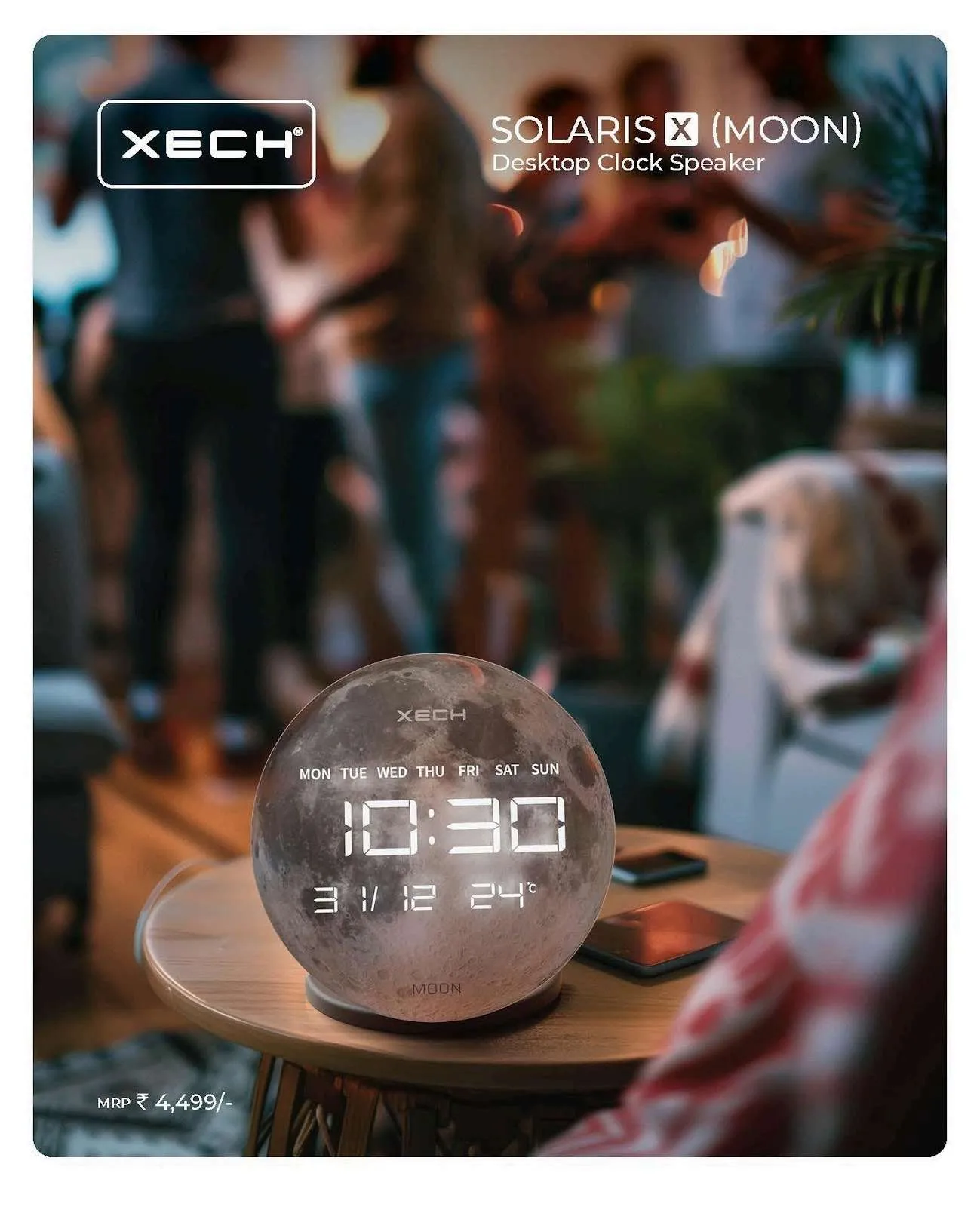 XECH Solaris X Moon spherical desktop clock speaker with a lunar finish showing time, date and temperature, on a table.