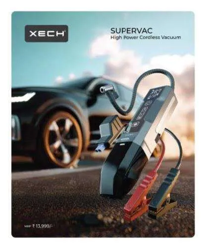 XECH Supervac cordless handheld vacuum in black and silver with flexible hose and battery clamps, beside a dark luxury car at sunset.