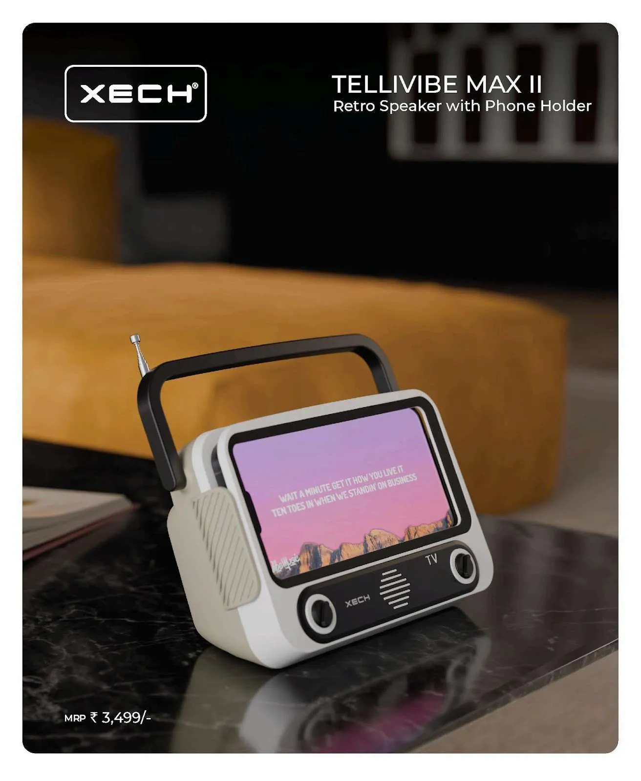 White XECH Tellivibe Max II retro TV speaker holding a phone screen, on a dark marble surface