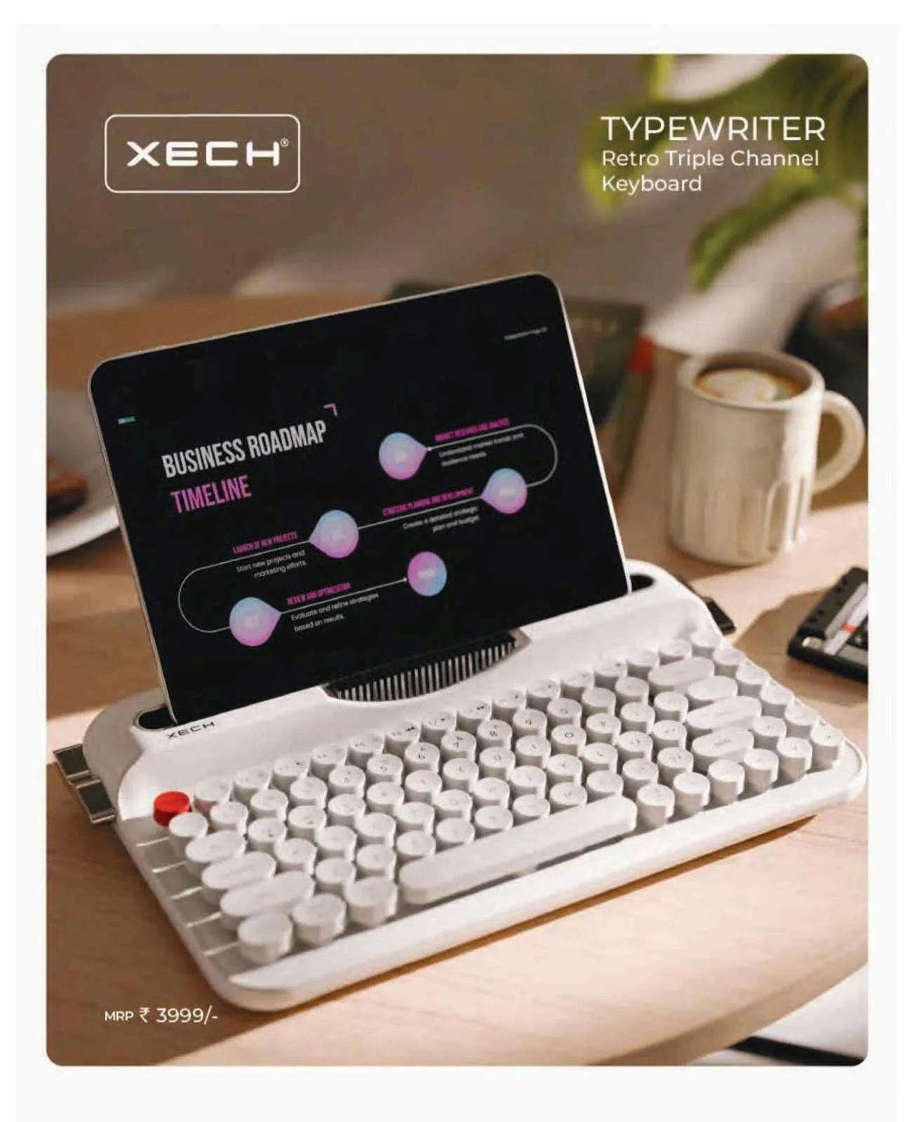 White XECH Typewriter retro keyboard with round keys holding a tablet displaying a roadmap on a wooden desk beside a coffee mug.
